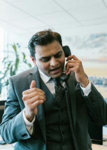 Focused businessman taking an important phone call in a modern office setting.